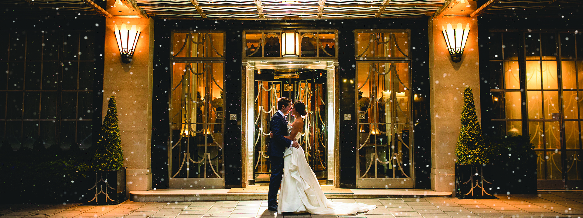 Bride and groom standing outside Claridge's hotel 