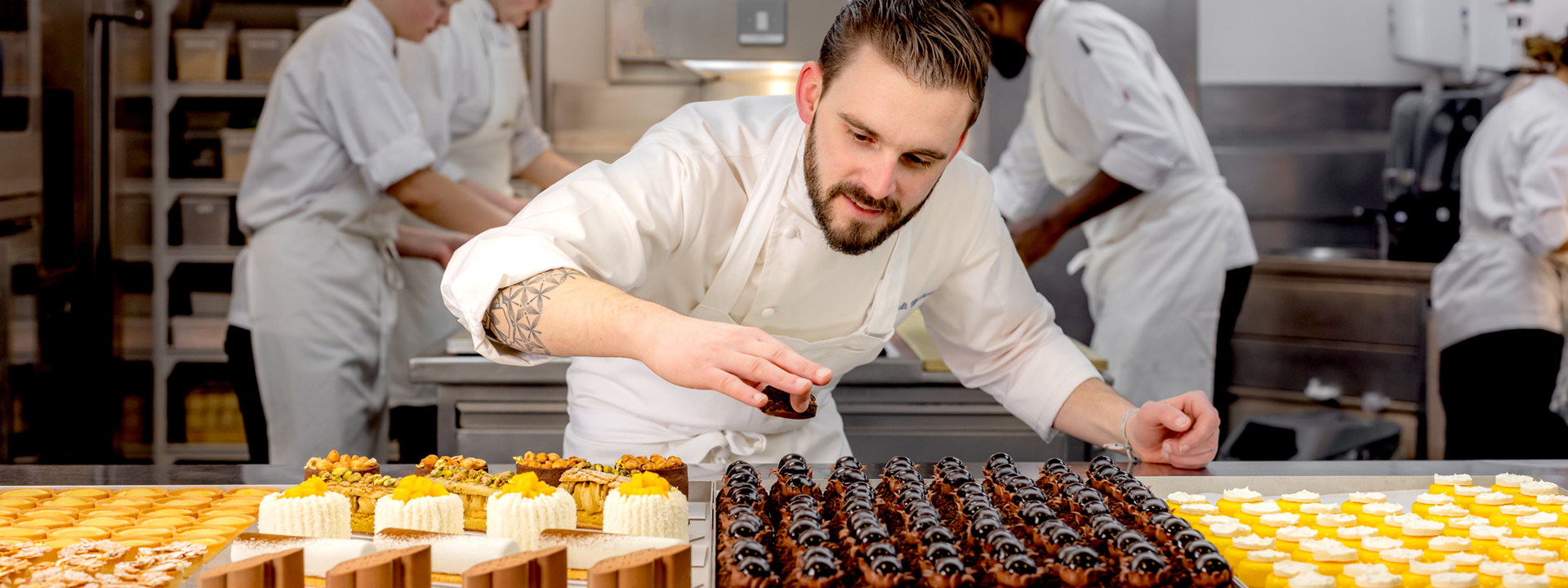 Chef Thibault Hauchard putting pastries on the pass at Claridge's