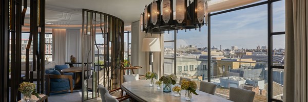 Dining table in a light-filled space with floor to ceiling windows